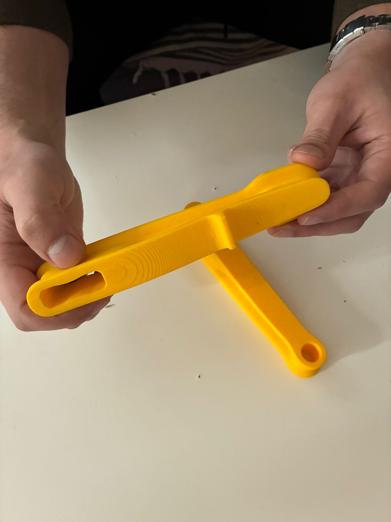Yellow 3D printed Bulut F-Clamp prototype during ergonomic hand testing