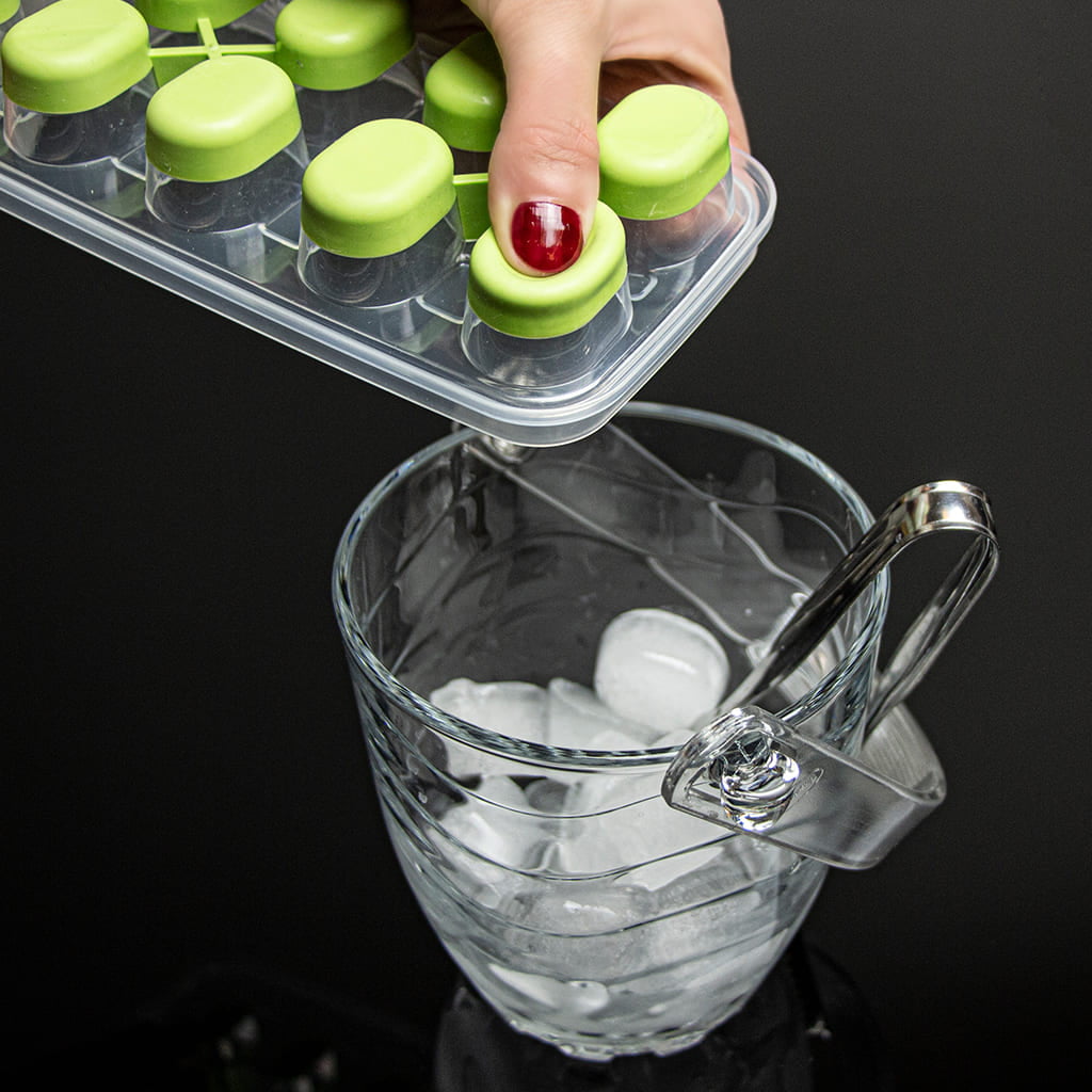 Produced DecoBella ice tray releasing a cube into a glass